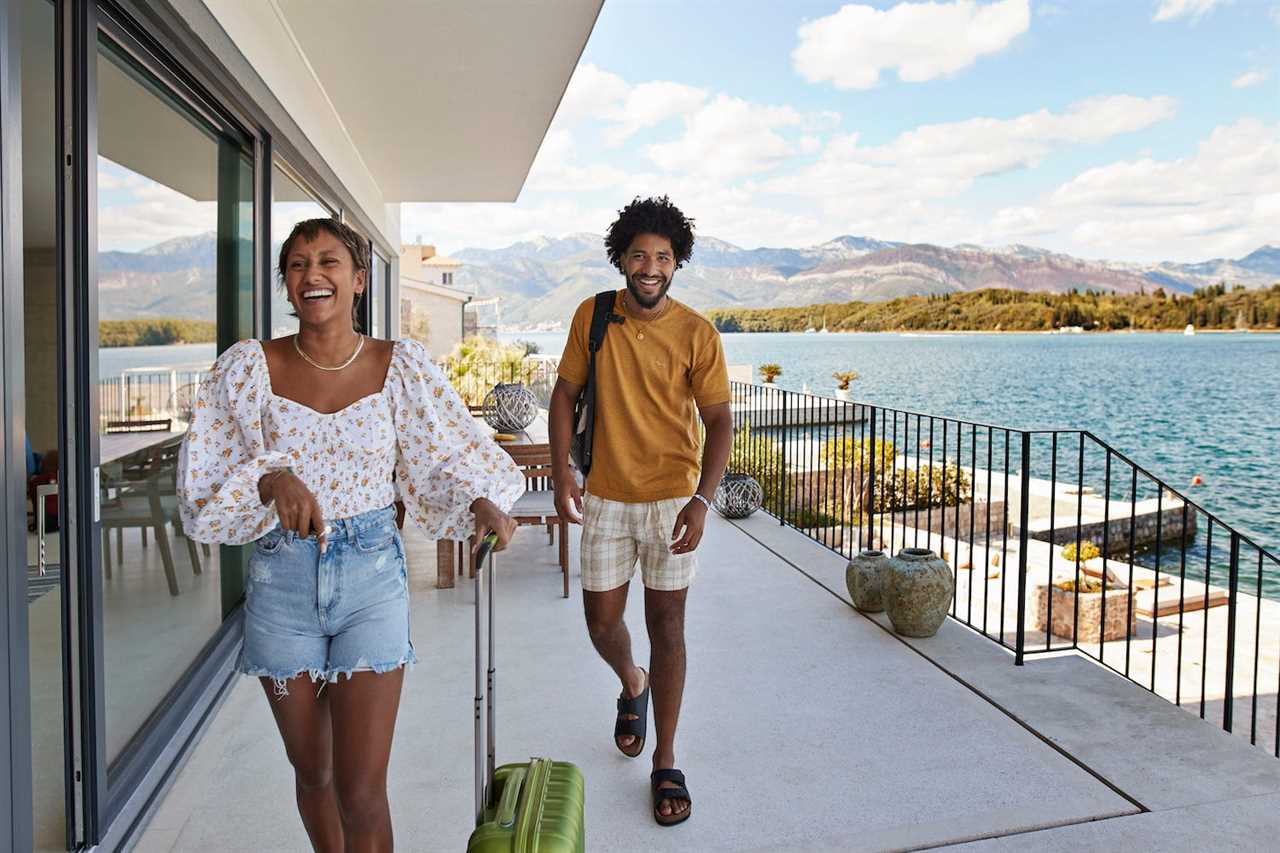 A couple with luggage enters a hotel.