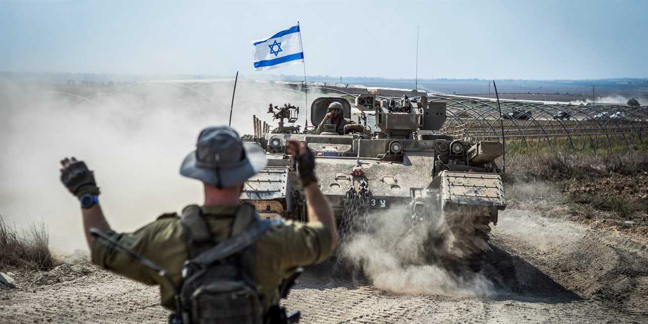 Israeli military combat vehicles and tanks are seen near the Israeli-Gaza border on Oct. 14, 2023.