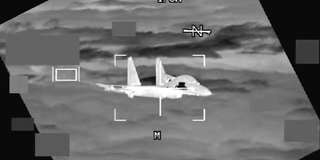 A screenshot from the USINDOPACOM video showing a Chinese J-11 fighter jet intercepting a US Air Force B-52 aircraft.