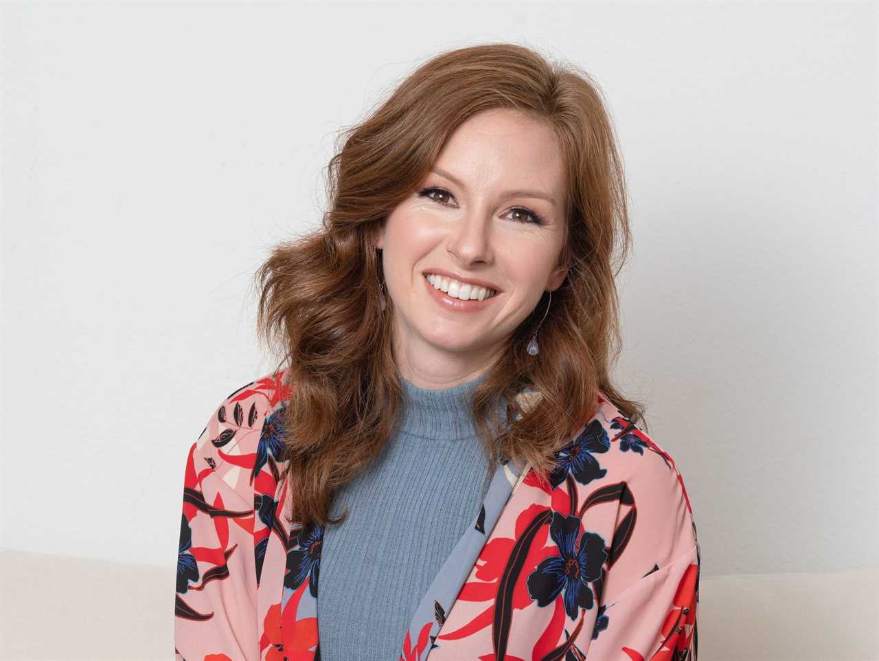 Headshot of Meredith Noble, who is wearing a gray shirt and floral cardigan.