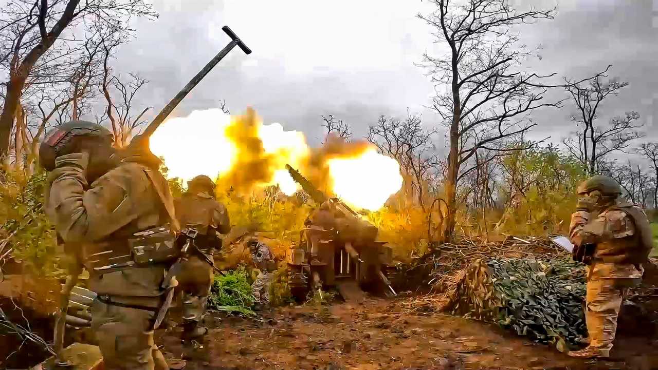 A Russian howitzer fires toward Ukrainian positions at an undisclosed location.