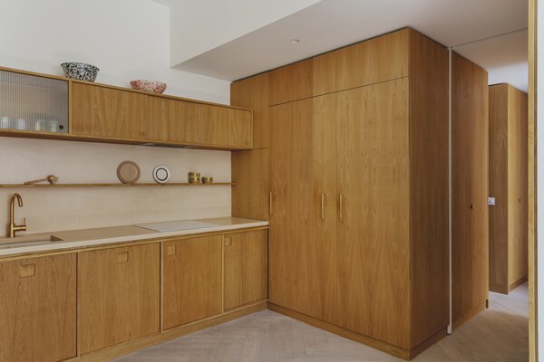 Oak Cabinets, Cupboards, and Banquet Seating Reset a Small East London Flat