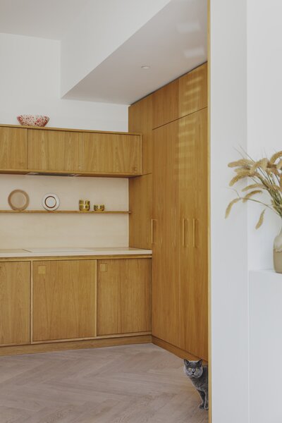 Oak Cabinets, Cupboards, and Banquet Seating Reset a Small East London Flat