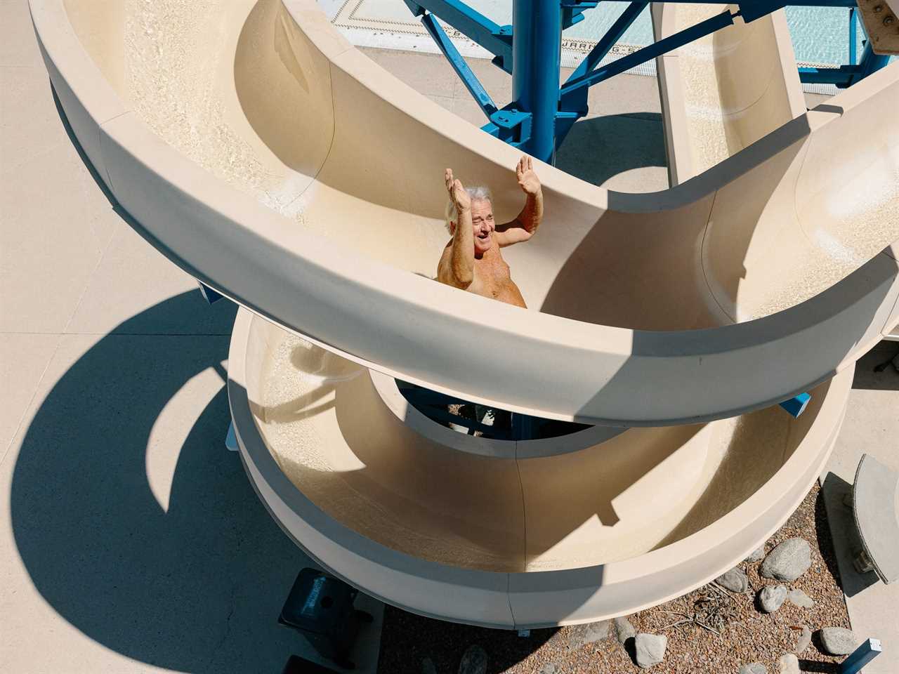 Tom Farley, in his 70s, rides the waterslide at the Drayson Center in Loma Linda, California.