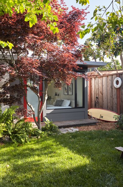 The covered wooden walkway travels the length of the house and connects the circulation with the main home. 