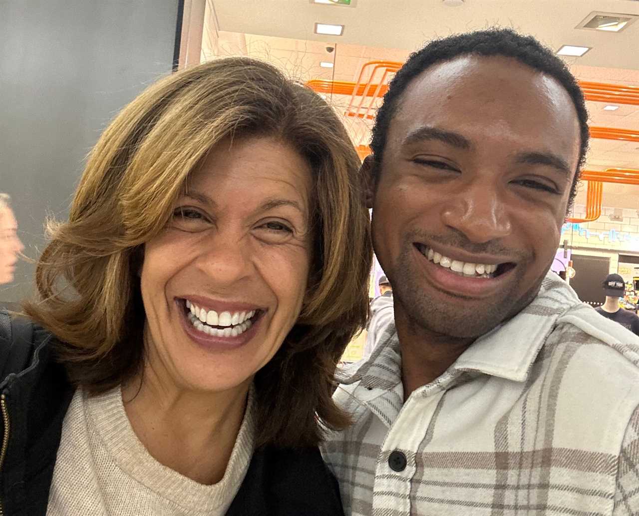 A man smiles next to Hoda Kotb.