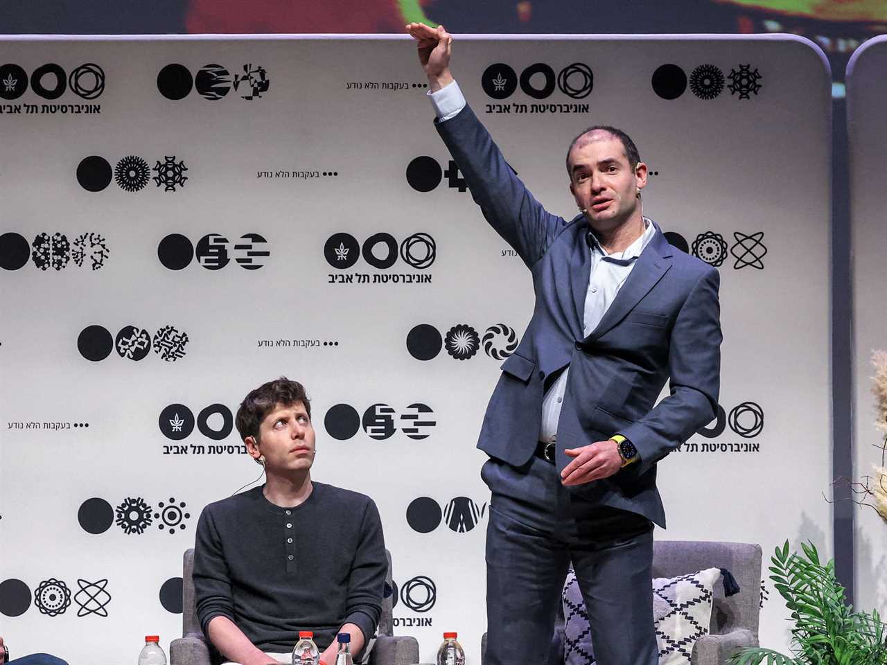 Sam Altman (C), US entrepreneur, investor, programmer, and founder and CEO of artificial intelligence company OpenAI, and the company's co-founder and chief scientist Ilya Sutskever (R), speak together at Tel Aviv University in Tel Aviv on June 5, 2023.