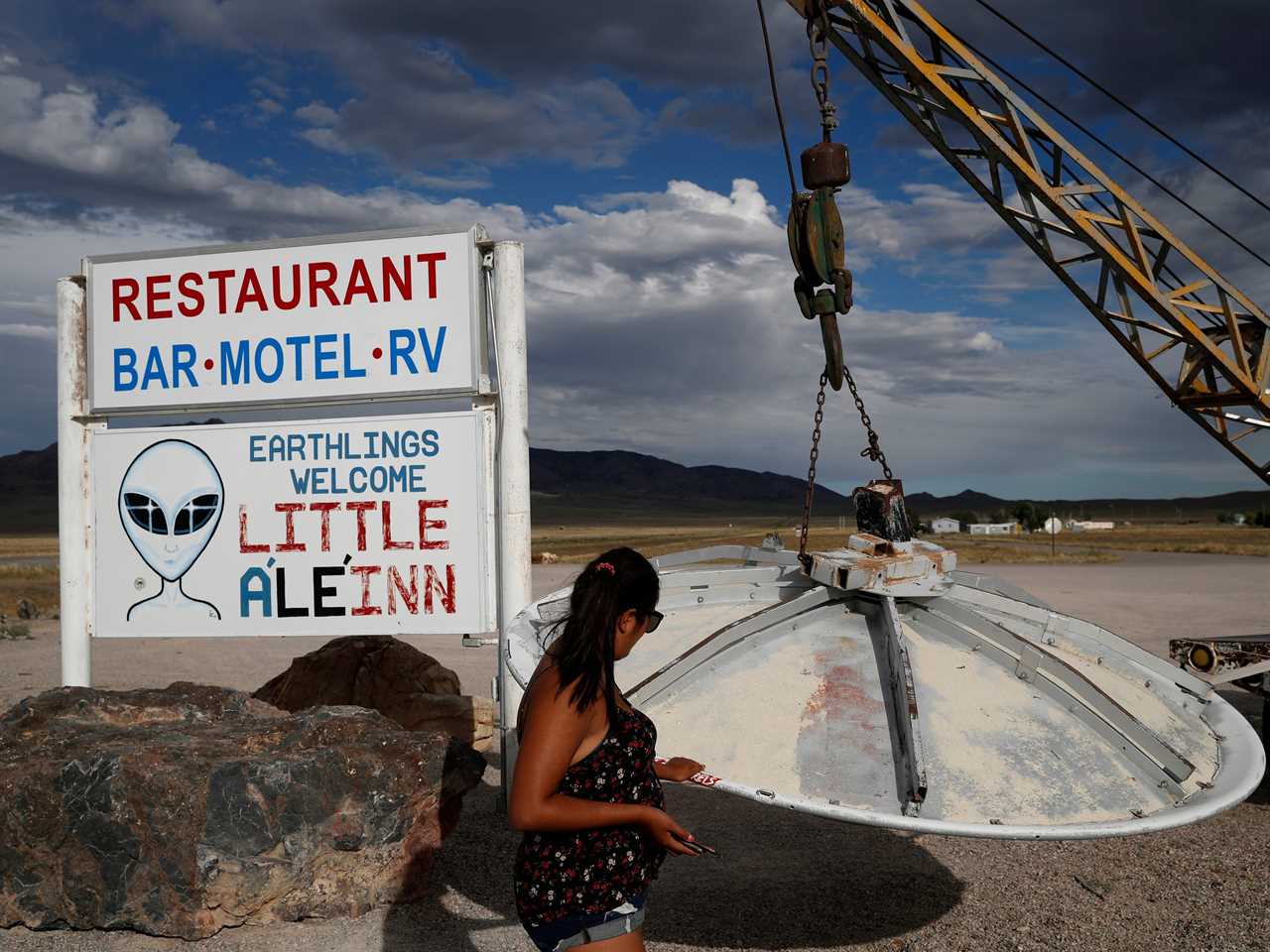 A woman looks at a UFO display outside of the Little A'Le'Inn, in Rachel, Nev., the closest town to Area 51, July 22, 2019.