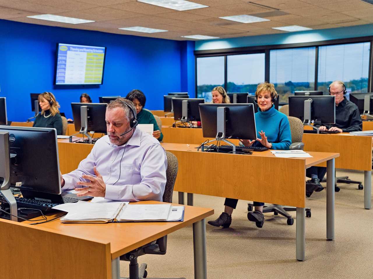 a group of people answering phone calls