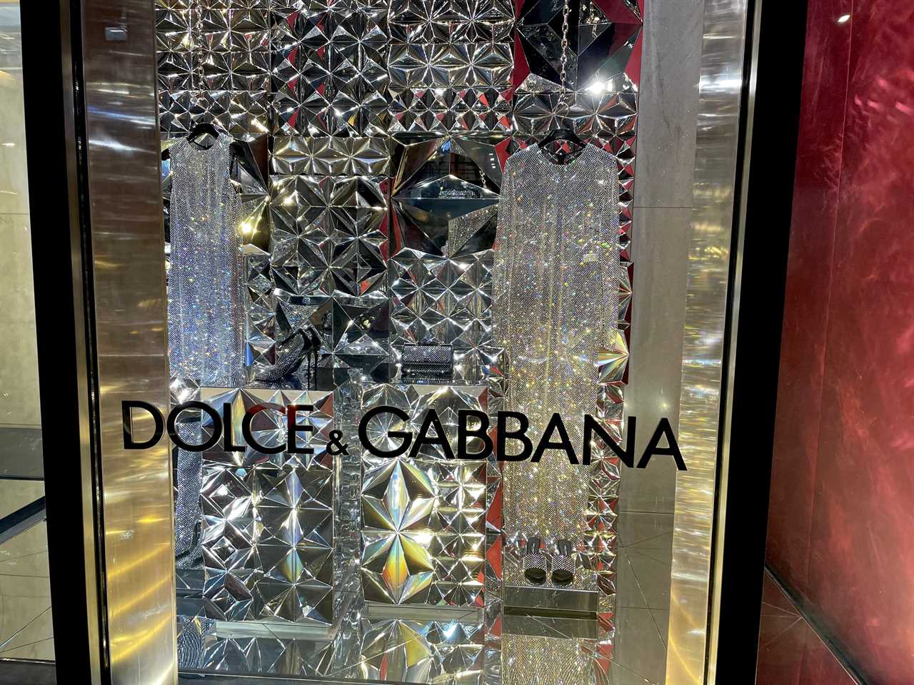 a window at Dolce & Gabbana shows lots of silver and sparkle