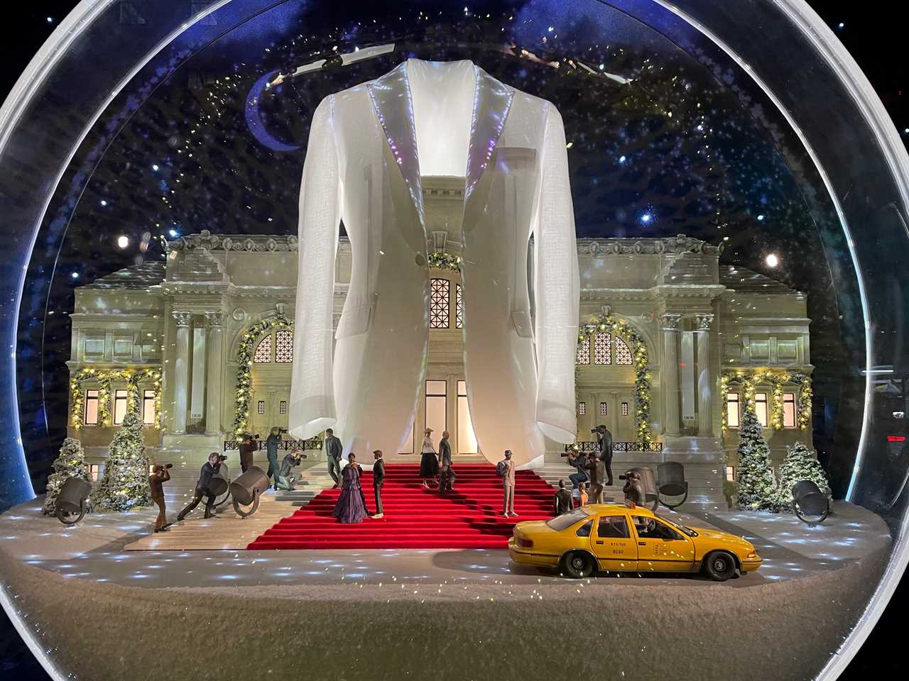 a holiday window at Saks Fifth Avenue shows a scene set in New York City