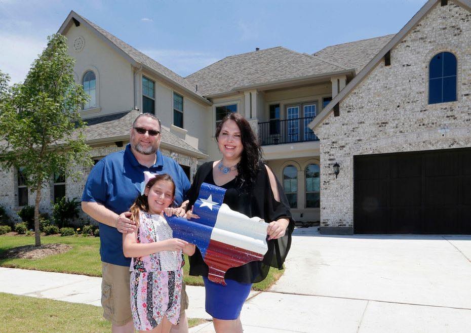 Marie Bailey stands with her family in front of her home in Prosper, Texas.