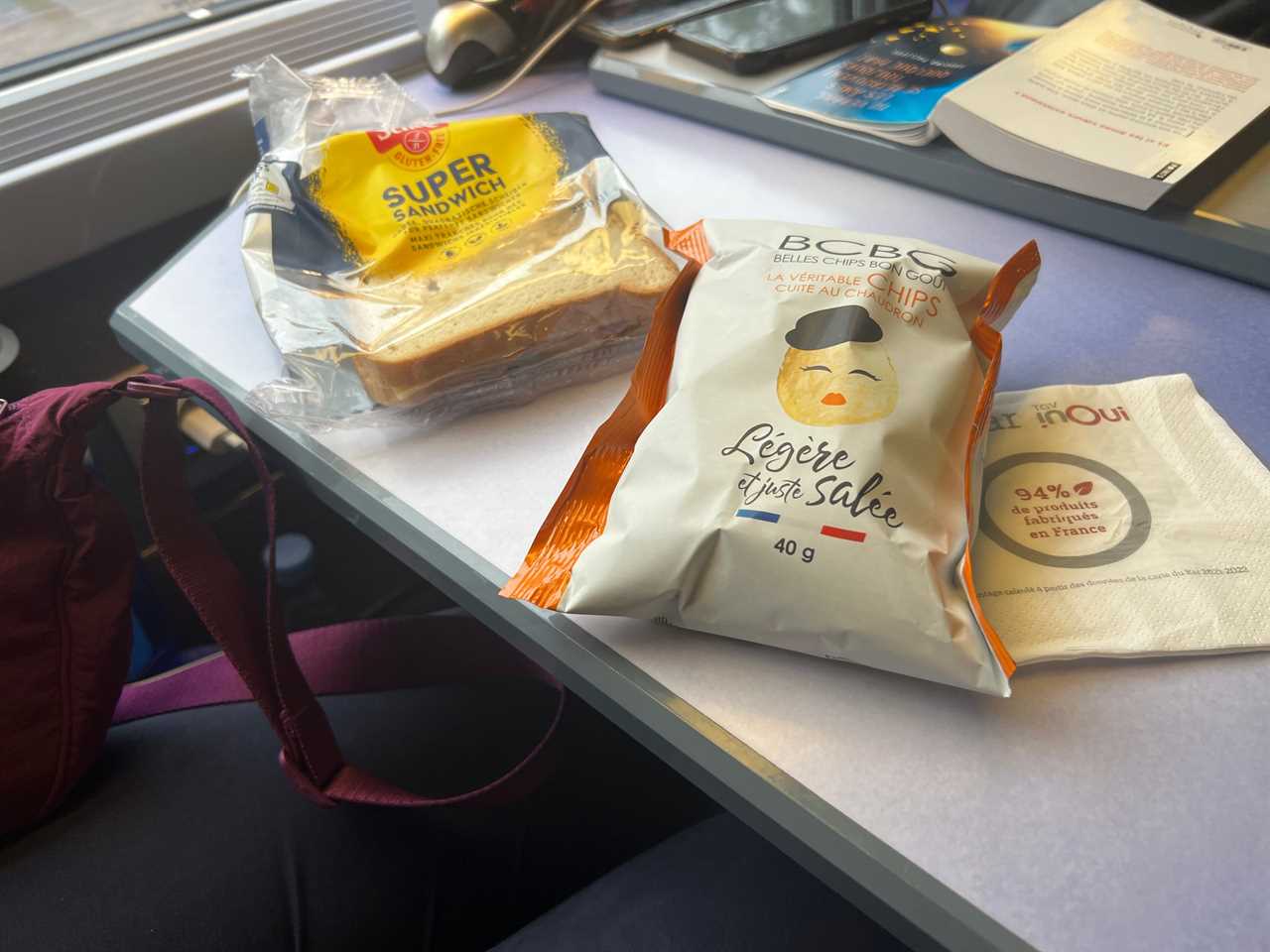 A sandwich and bag of chips.