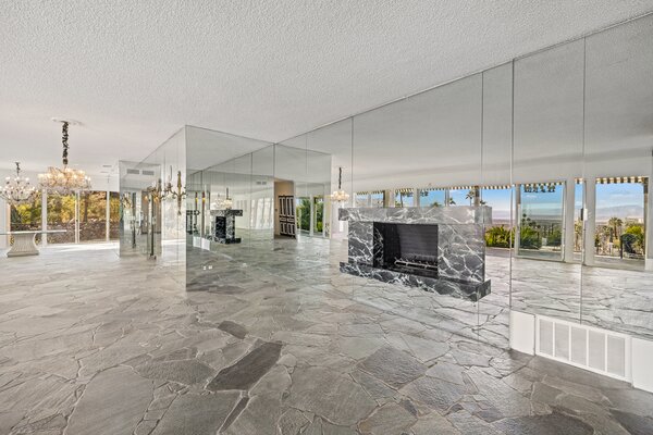 Mirrored walls and crystal chandeliers run throughout the open-plan living areas.