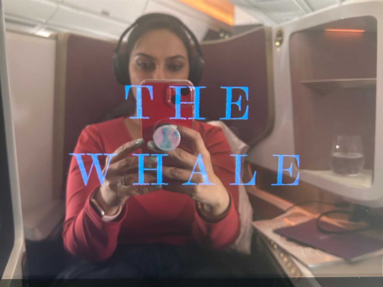 Noor Anand Chawla, who is watching "The Whale," is seen in the reflection of the TV screen.