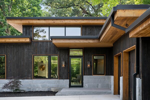 Built in 2022, the home features a Cypress and Cedar exterior and flat-lined roof, inspired by modern Balinese architecture.