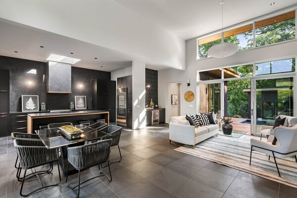 Sliding glass doors and clerestory windows allow the main living areas to be drenched with natural light. Black Venetian Plaster walls in the kitchen pop against the stark white ceilings.