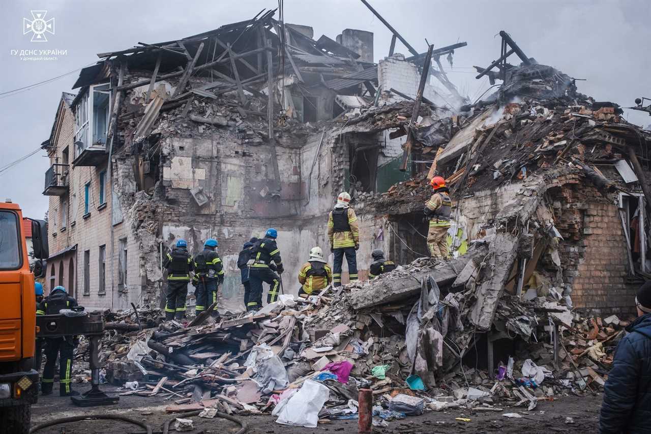 Rescuers work at a site of a residential building that was heavily damaged by a Russian missile strike