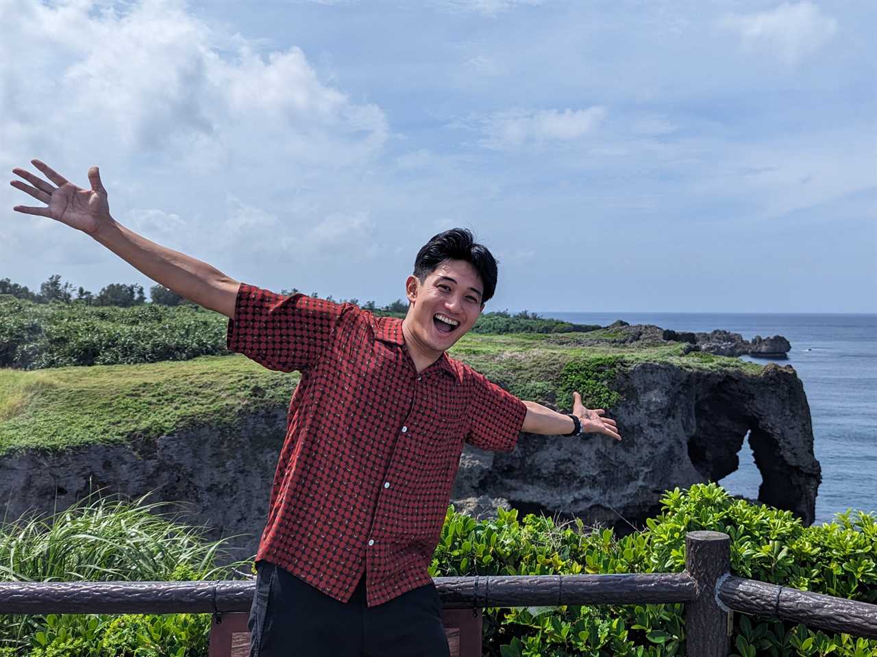 Man posing for a photo next to the ocean