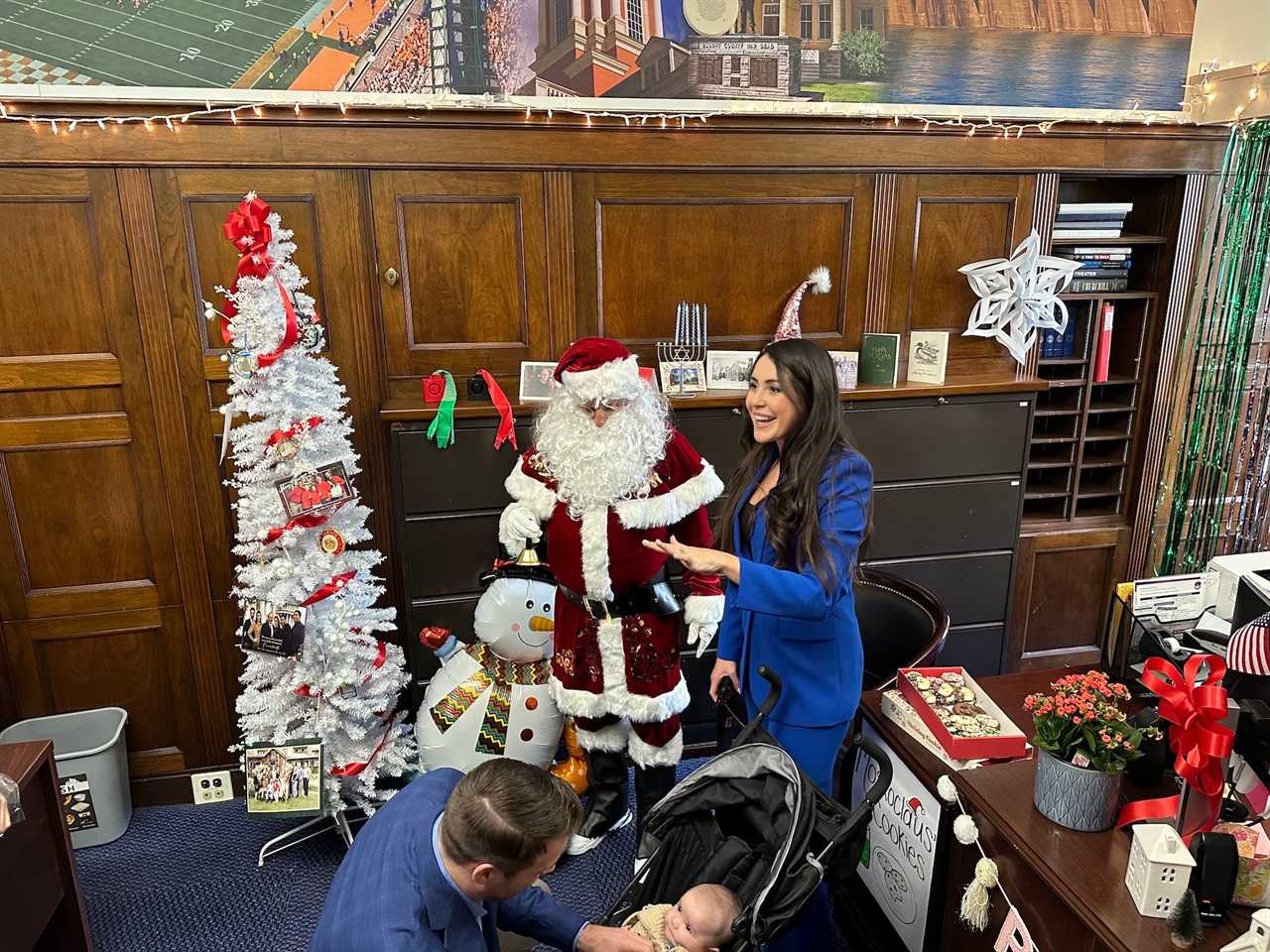 Rep. Luna prepares to pose with "Moskoclaus."