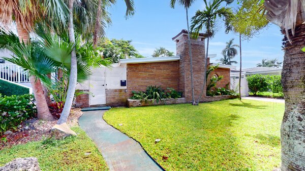 A wooden door leads to the main entrance, as well as the home's fully fenced-in backyard.