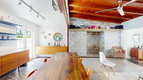 Exposed beams span across the main living areas, enhancing the overall sense of space.