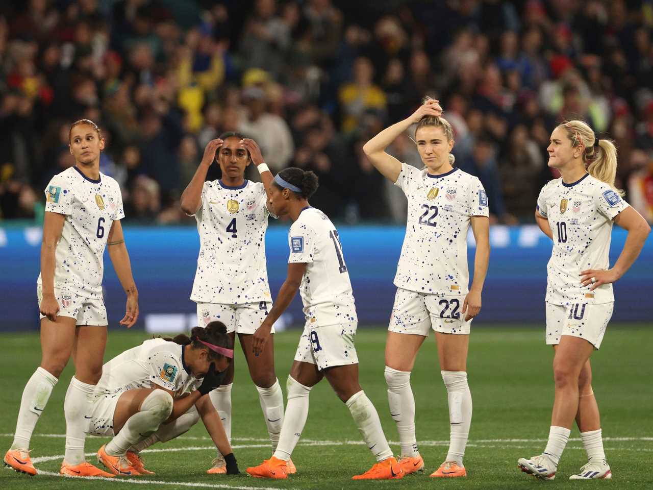 US Women's National Team players react after losing their 2023 World Cup Round of 16 soccer match against Sweden in a penalty shootout.