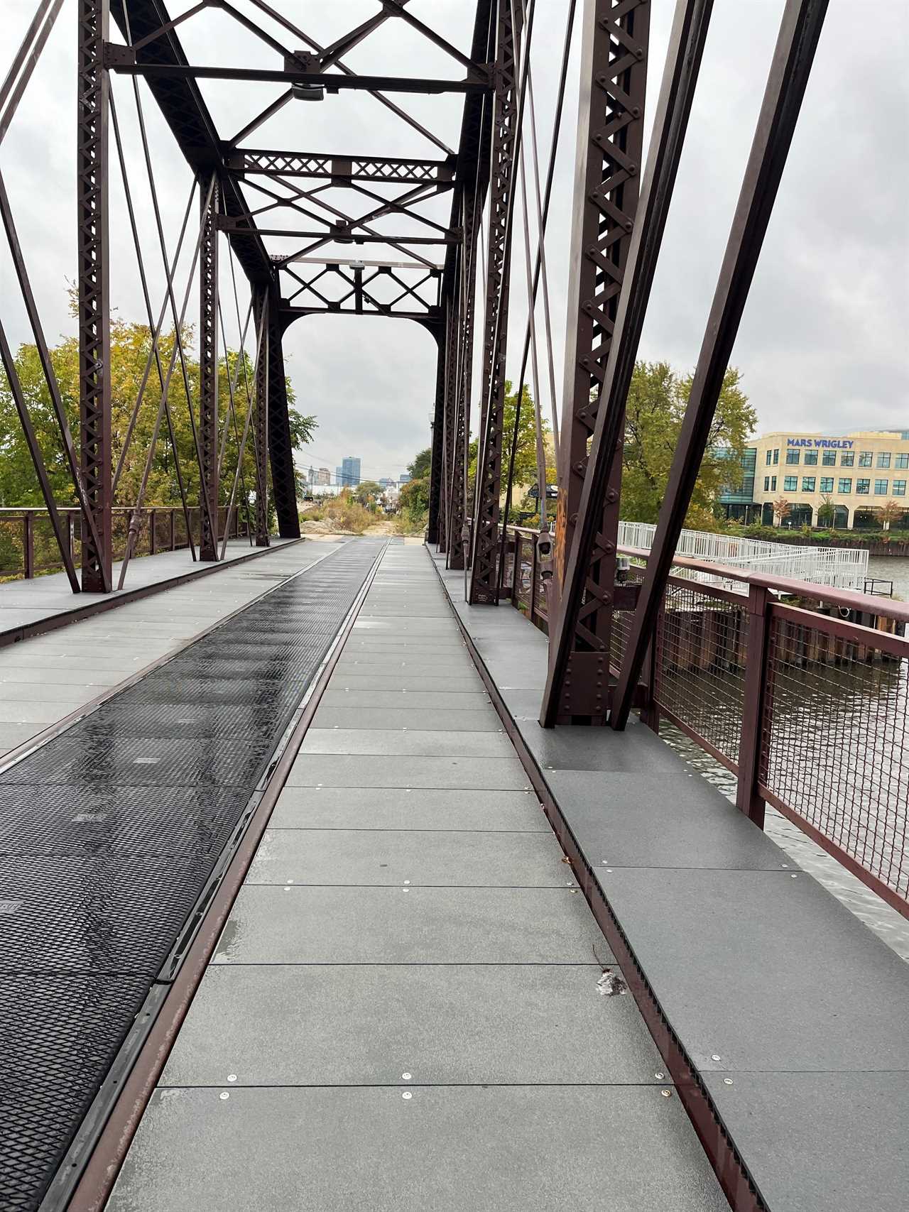 Andrew walks over a bridge to the office.