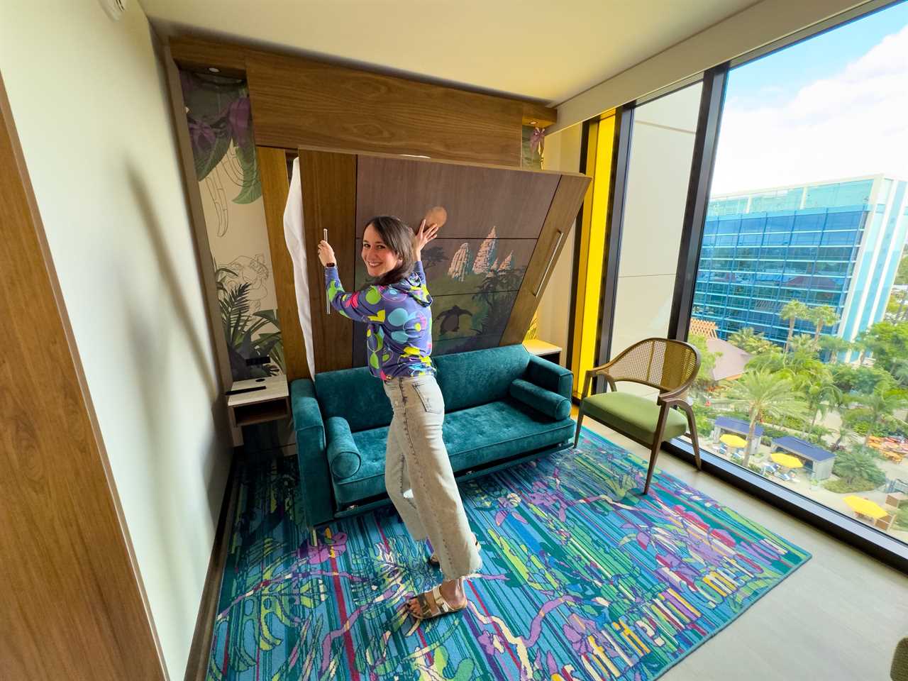 Author Brooke McDonald pushing a Murphy bed back into the wall at a Disneyland Hotel duo studio