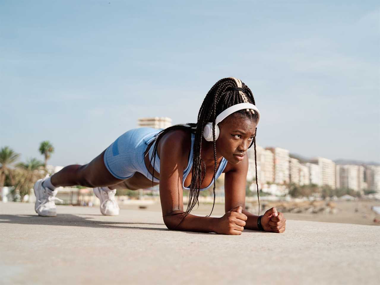 A woman works out by the beach.