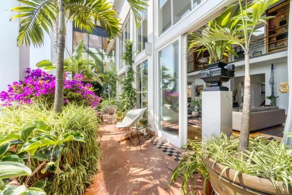 Lush vegetation awaits in nearly every nook and cranny of the home, both inside and out.