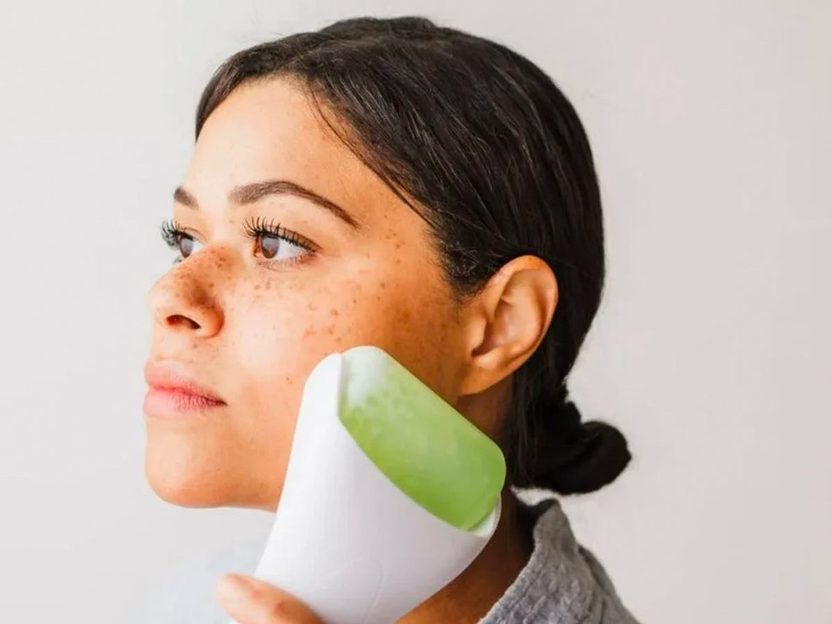 Person using a Kanjo Pain Relief Ice Roller on their face.