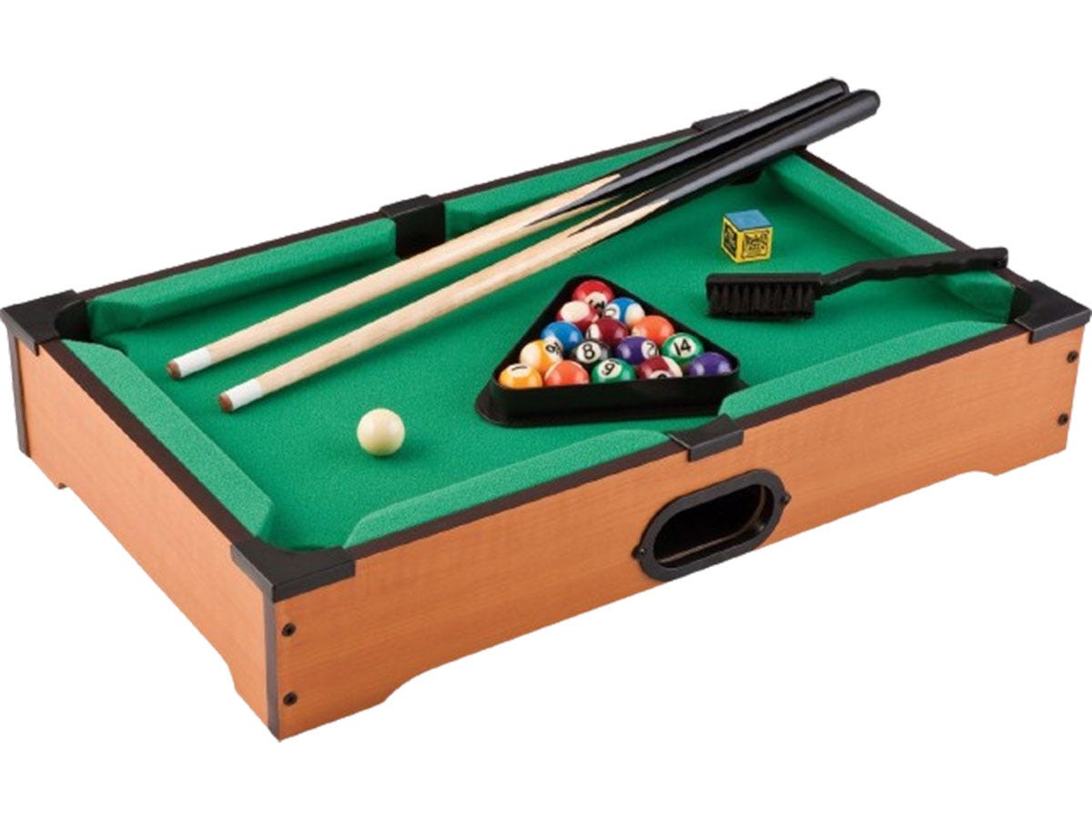 A green and brown mini pool table with pool sticks and billiard balls.