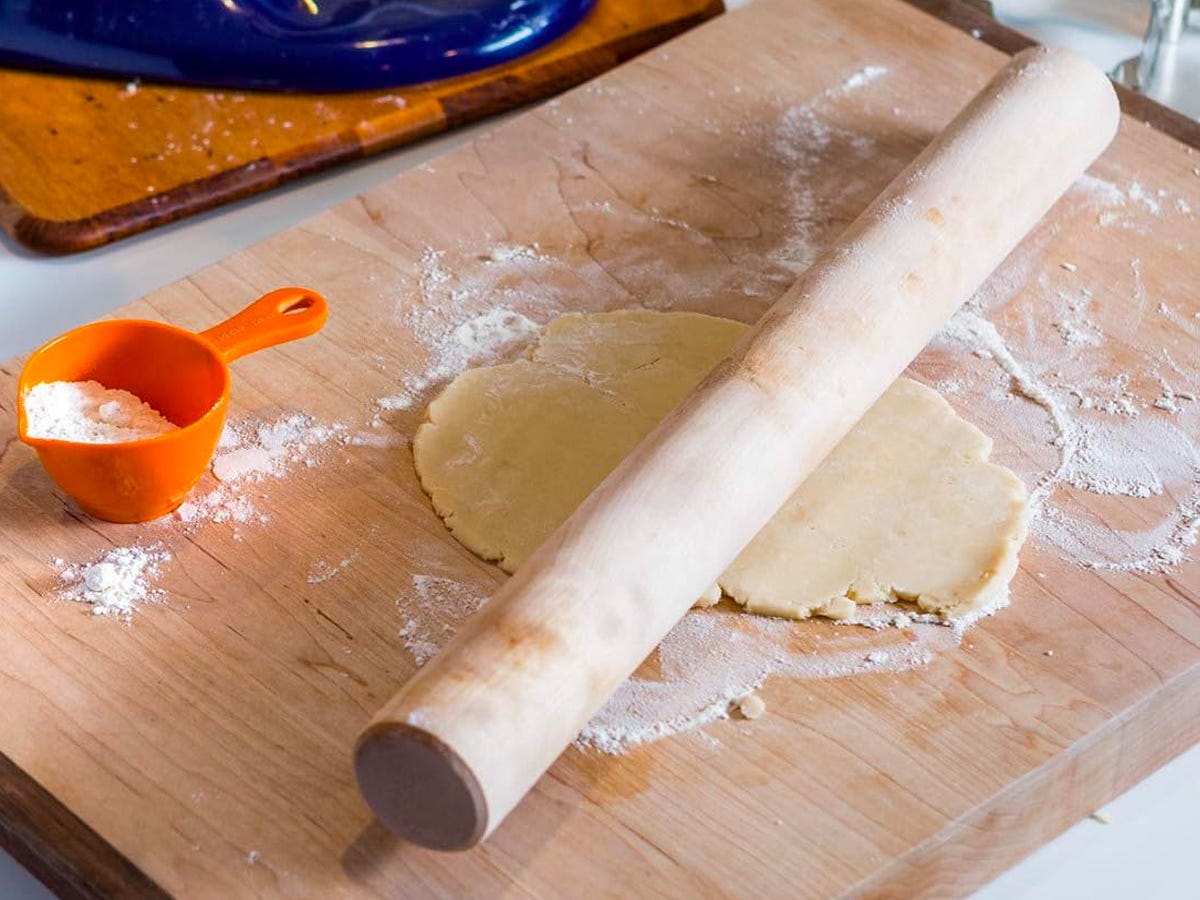 The JK Adams Wooden Rolling Dowel laying on some cookie dough on a bakers work station.