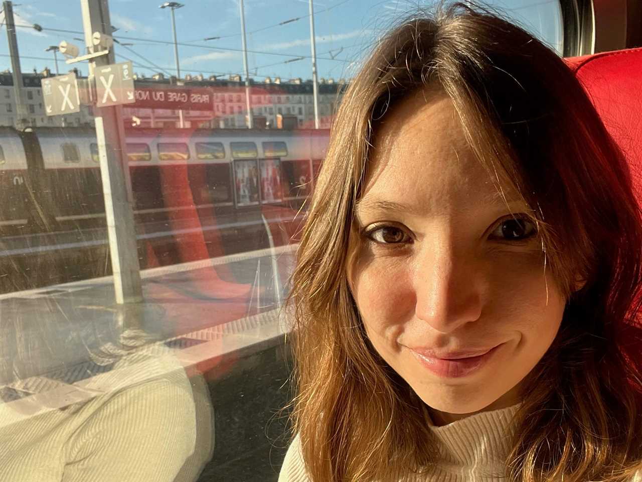 charlotte posing for a selfie in her seat on a eurostar train