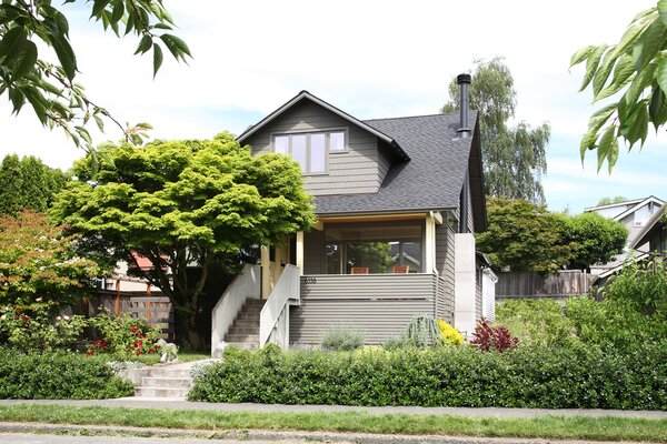 Removing the exterior white siding and creating a new cantilevered concrete stoop was the first order of business. "Both Julie and Chris being structural engineers, I thought we should show off what they do with this cantilevered concrete slab for the new front stoop,