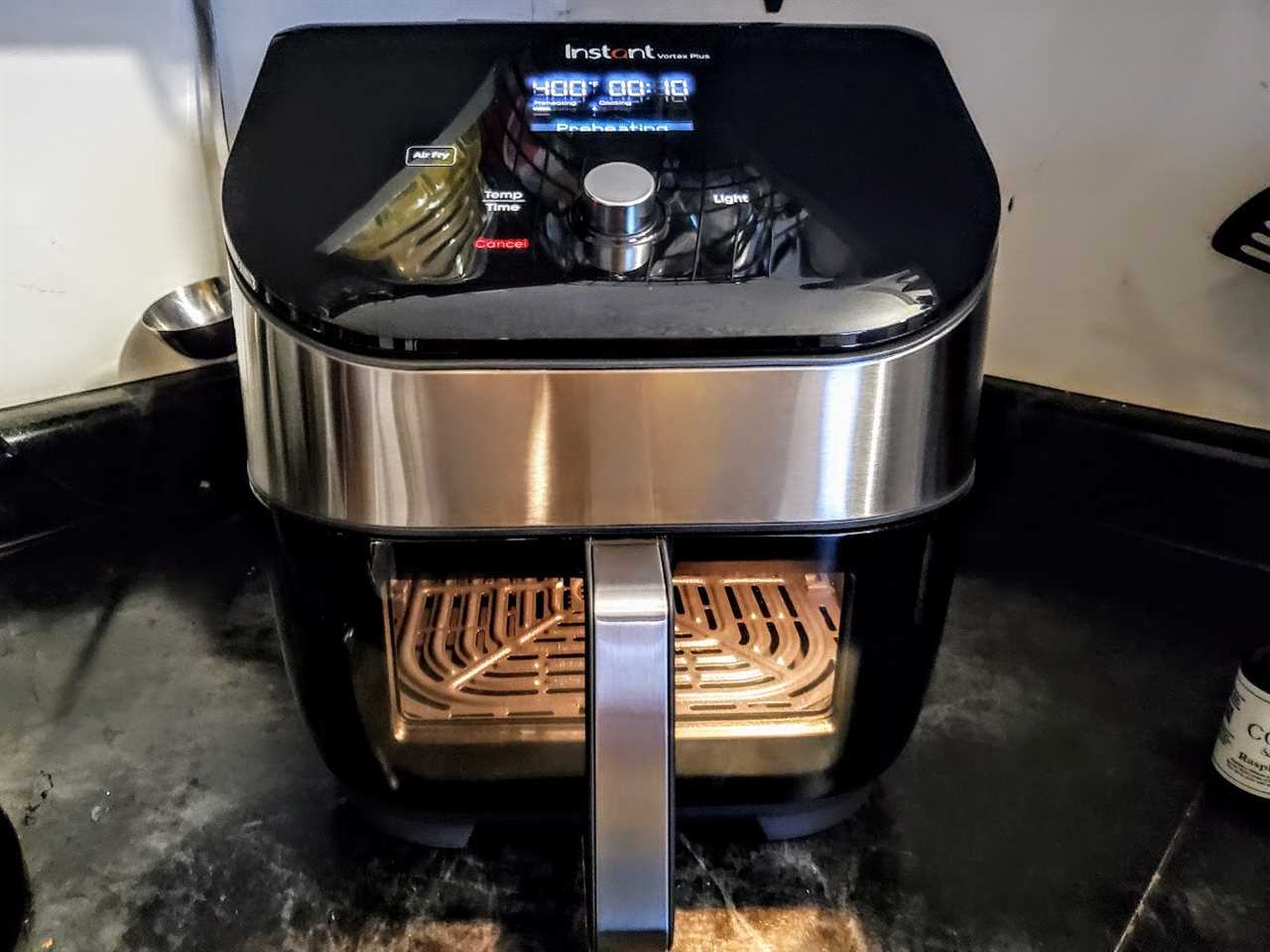 The Instant Vortex Plus Air Fryer Oven with ClearCook is displayed on a kitchen counter.