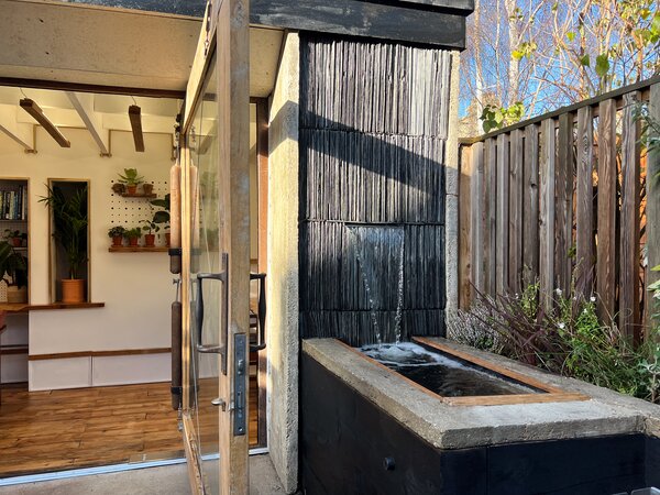 A water feature and bird bath are built into the studio’s facade.