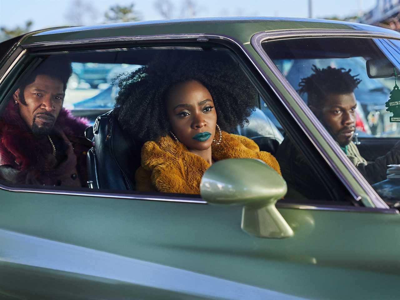 screenshot of Jamie Foxx, Teyonah Parris, and John Boyega in a car in a scene from they cloned tyrone