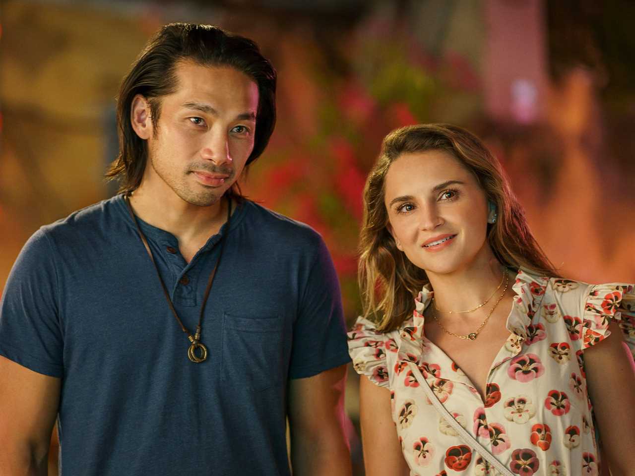 Scott Ly and Rachael Leigh Cook standing next to each other in a scene from A Tourist's Guide to Love