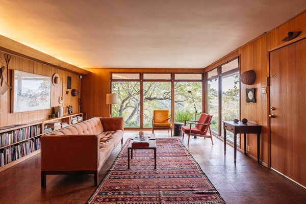 A trove of original design awaits inside, including the wood-paneled walls in the living room.