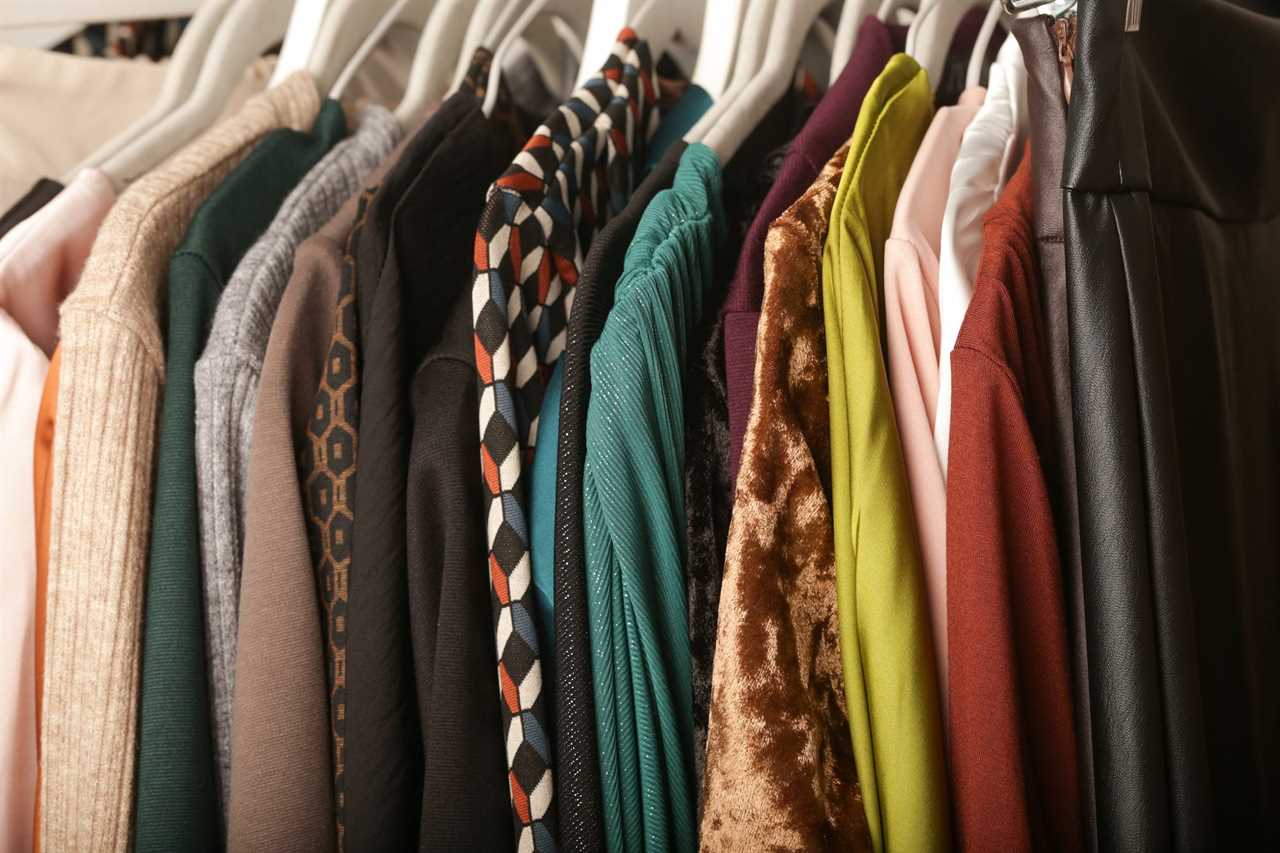 Used clothes on a rack at a secondhand store.