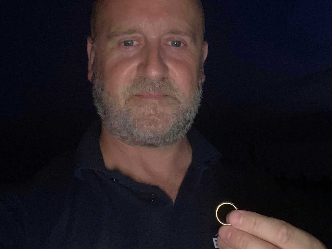 Darren Wiles with a ring he retrieved from Southbourne beach.