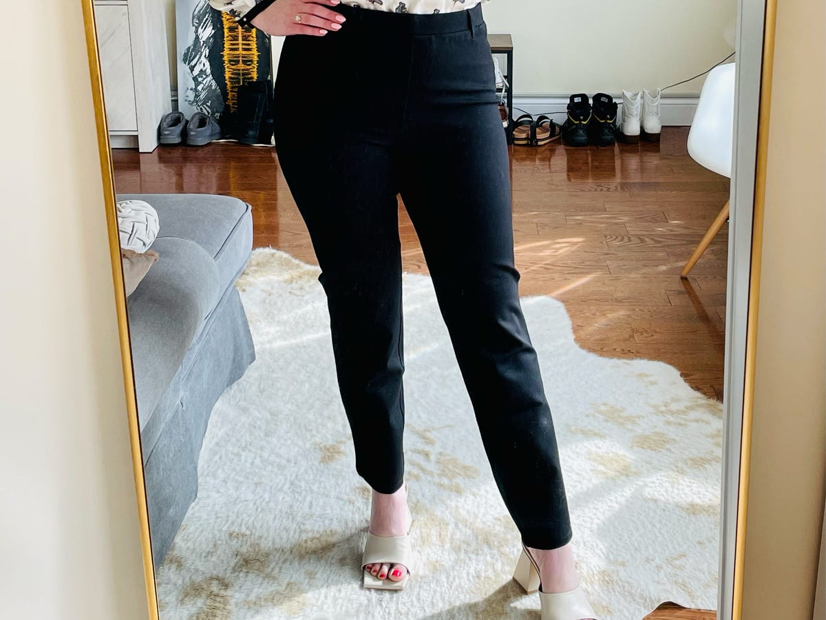 A person wearing the Quince Ultra-Stretch Ponte Straight Leg Pant in black.