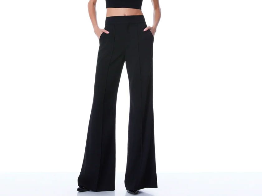 A person wearing the Alice & Olivia Dylan High Waisted Wide Leg Pant in black.