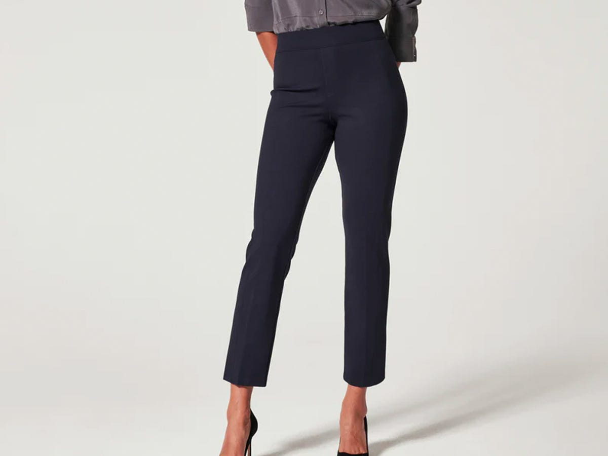 A person wearing the Spanx The Perfect Pant Slim Straight in classic navy.