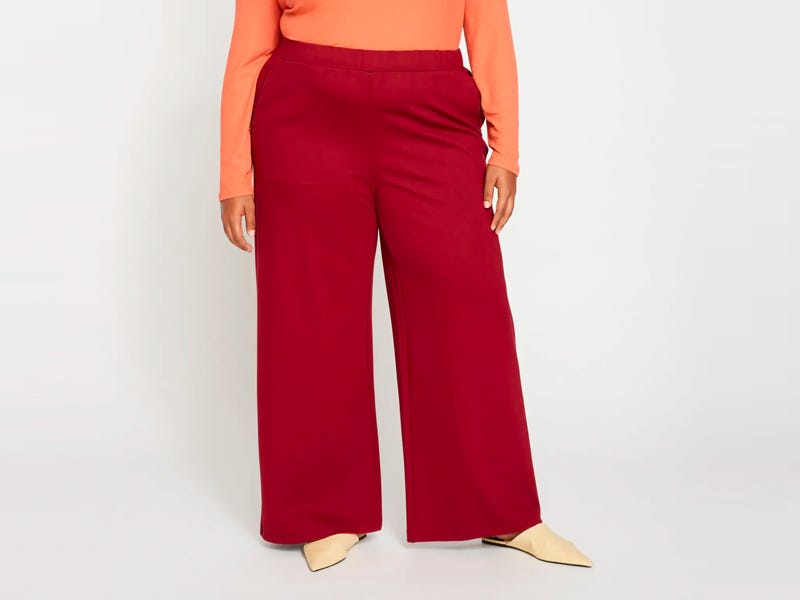 Person wearing the Universal Standard Stephanie Wide Leg Pants in red.