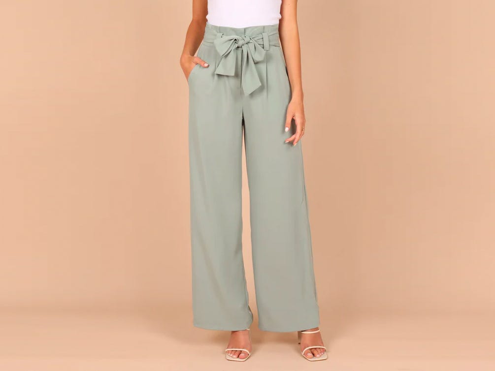 Person wearing the Petal & Pup Kieran Pants in sage green.