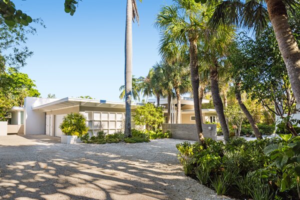 The one-level home sits tucked away on a tranquil waterfront lot, surrounded by tall trees and native vegetation. Lido Beach and St. Armand's Circle are just a short stroll away.