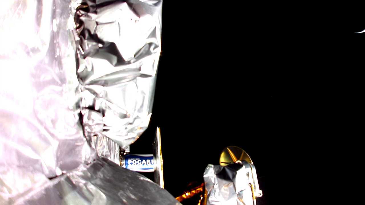 A picture taken from an onboard camera shows on of the sides of Astrobotic's Peregrine lander. A small sliver of light is seen on the right hand side.